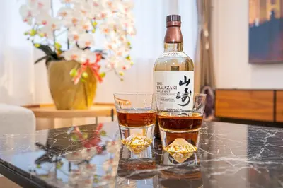a bottle of wine and a glass on a table at Asakusa,Ginza,Ueno,Skytree,Stn&Conv 1min ,Family suite,45 Mins to Airport,Kiyoka Villa 清禾 in Tokyo