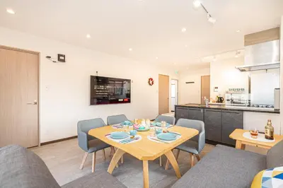 a dining room with a table and chairs and a kitchen at Asakusa,Ginza,Ueno,Skytree,Stn&Conv 1min ,Family suite,45 Mins to Airport,Kiyoka Villa 清禾 in Tokyo