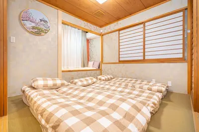 a large bed in a room with a window at Asakusa,Ginza,Ueno,Skytree,Stn&Conv 1min ,Family suite,45 Mins to Airport,Kiyoka Villa 清禾 in Tokyo