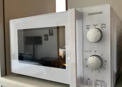 a white microwave with two knobs on it at LuckyHouse\u6d45\u8349 \u6210\u7530\u7fbd\u7530\u76f4\u884c in Tokyo