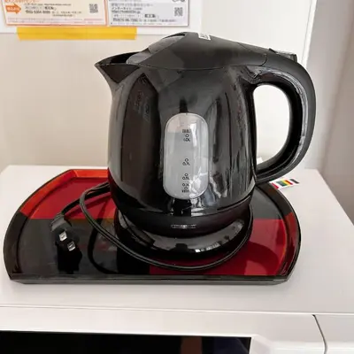 a black coffee pot on a tray on a counter at LuckyHouse\u6d45\u8349 \u6210\u7530\u7fbd\u7530\u76f4\u884c in Tokyo