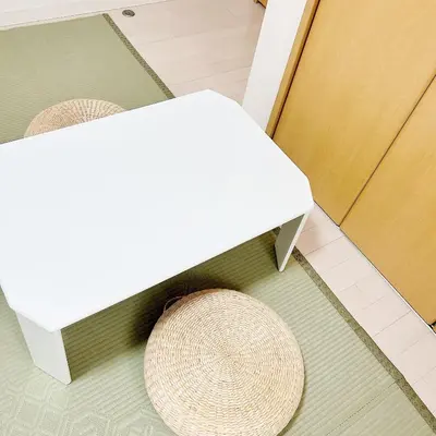 a white bench and a rattan stool on a floor at LuckyHouse\u6d45\u8349 \u6210\u7530\u7fbd\u7530\u76f4\u884c in Tokyo
