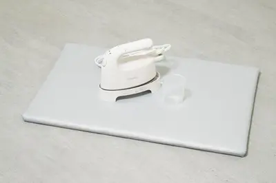 a sewing machine sitting on top of a white laptop at GIVE Kagurazaka in Tokyo