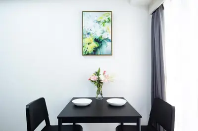 a dining room table with a vase of flowers at Shinjuku Serenity Studio-L06 in Tokyo