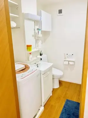 a white bathroom with a toilet and a sink at KYARA Hotel \u4e80\u6238402 in Tokyo