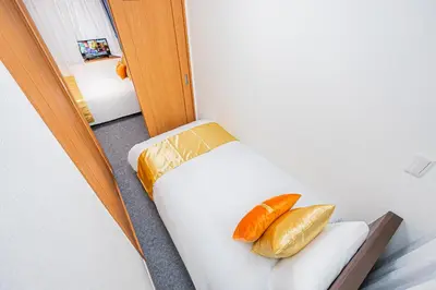 a room with a bed with two carrots on it at KYARA HOTEL \u4e80\u6238b in Tokyo