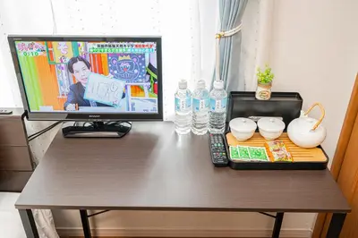 a desk with a computer on top of a table at KYARA HOTEL \u4e80\u6238b in Tokyo