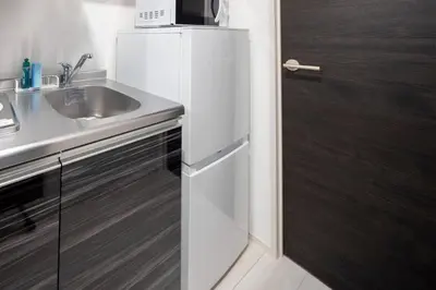 a white refrigerator in a kitchen with a sink at fl\u30ec\u30b8\u30c7\u30f3\u30b9\u795e\u5bae\u5fa1\u82d1IV in Tokyo