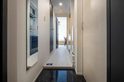 a hallway of a house with a reflection in the floor at fl\u30ec\u30b8\u30c7\u30f3\u30b9\u795e\u5bae\u5fa1\u82d1IV in Tokyo