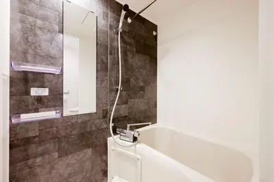 a bathroom with a shower and a toilet and a mirror at fl\u30ec\u30b8\u30c7\u30f3\u30b9\u795e\u5bae\u5fa1\u82d1IV in Tokyo