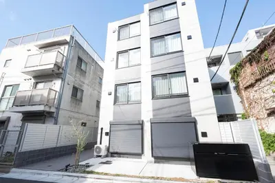 an apartment building with two garage doors at fl\u30ec\u30b8\u30c7\u30f3\u30b9\u795e\u5bae\u5fa1\u82d1IV in Tokyo