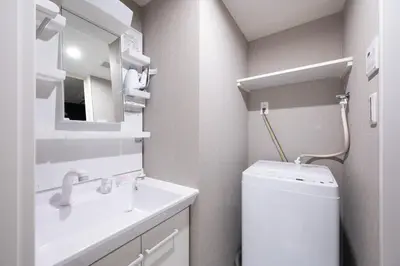 a bathroom with a sink and a toilet and a mirror at Legend COURT\u66f3\u821f in Tokyo