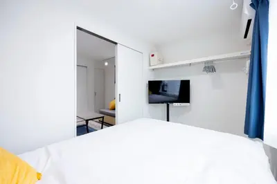 a bedroom with a white bed and a mirror at Legend COURT\u66f3\u821f in Tokyo