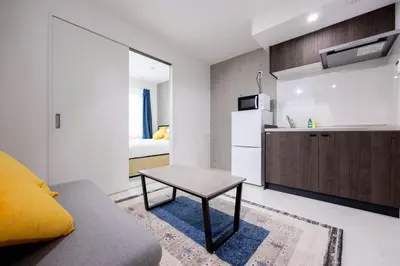 a living room with a couch and a table at Legend COURT\u66f3\u821f in Tokyo