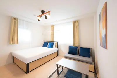a small room with a bed and a chair at MAT SHIBUYAHONMACHI in Tokyo
