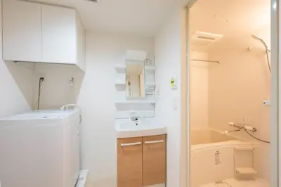 a small bathroom with a sink and a washing machine at MAT SHIBUYAHONMACHI in Tokyo