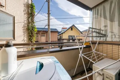 a bathroom with a toilet on a balcony at SKY Building 201 - Easy Airport Access & Comfortable Stay in Tokyo