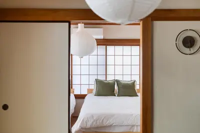 a bedroom with a bed and a mirror at SKY Building 201 - Easy Airport Access & Comfortable Stay in Tokyo