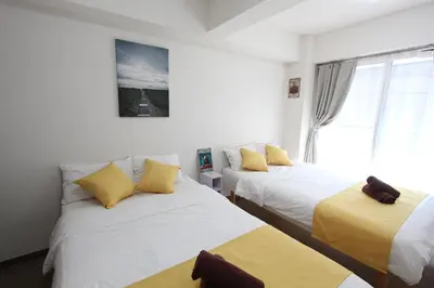 a bedroom with two beds and a window at LUANA in SHIBUYA in Tokyo