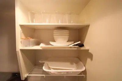 a closet with some dishes and bowls in it at LUANA in SHIBUYA in Tokyo