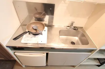 a small kitchen with a sink and a pot on a scale at LUANA in SHIBUYA in Tokyo