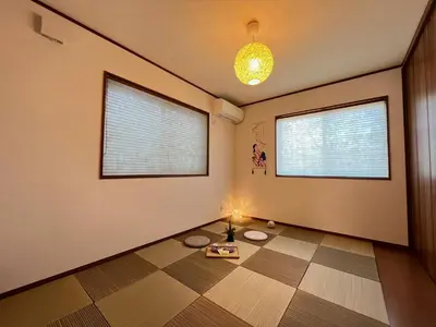 a room with two windows and a table on the floor at Charming New Home Launch: Direct access to Narita & Haneda Airports, Shinjuku, and Disneyland; Close to Asakusa & Akihabara! in Tokyo