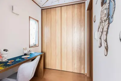 a room with a desk and a wooden door at Charming New Home Launch: Direct access to Narita & Haneda Airports, Shinjuku, and Disneyland; Close to Asakusa & Akihabara! in Tokyo
