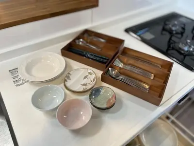 a group of dishes and a box on a counter at Charming New Home Launch: Direct access to Narita & Haneda Airports, Shinjuku, and Disneyland; Close to Asakusa & Akihabara! in Tokyo