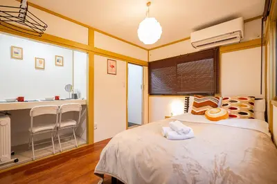a bedroom with a bed with two towels on it at Sunrise in Tokyo