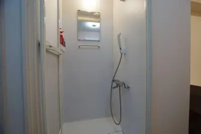 a shower in a bathroom with a glass door at TokyoGuest \u6d5c\u753a in Tokyo