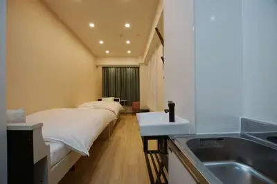 a hospital room with a bed and a sink at TokyoGuest \u6d5c\u753a in Tokyo