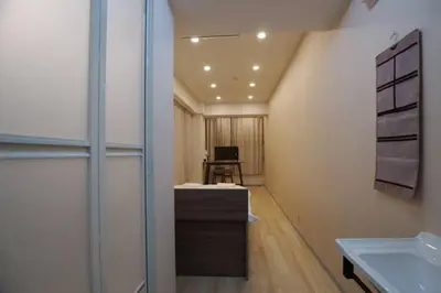a bathroom with a sink and a desk in a room at TokyoGuest \u6d5c\u753a in Tokyo