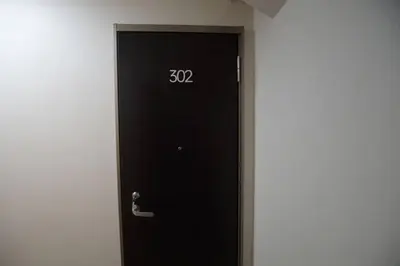 a black door with the number written on it at TokyoGuest \u6d5c\u753a in Tokyo