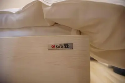 a bed with a sign that says grain on it at TokyoGuest \u6d5c\u753a in Tokyo