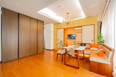 a living room with a table and a couch at KYARA Hotel\u30df\u30b9\u30df501 in Tokyo