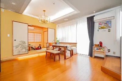 a living room with a table and a dining room at KYARA Hotel\u30df\u30b9\u30df501 in Tokyo