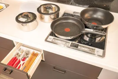 a kitchen counter with pots and pans on a stove at KYARA Hotel\u30df\u30b9\u30df501 in Tokyo
