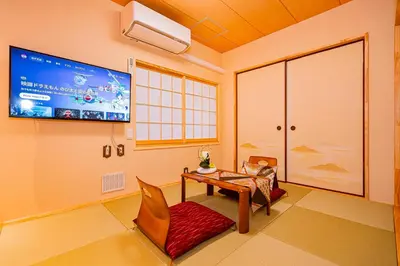 a room with a tv and a table and a chair at KYARA Hotel\u30df\u30b9\u30df501 in Tokyo