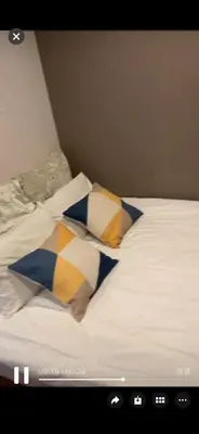 a bed with three pillows on top of it at Sky \u6674\u7a7a\u5854 \u72ec\u7acb\u53cc\u4eba\u95f4 \u4f46\u662f\u5171\u7528\u6d74\u5ba4\u5395\u6240 in Tokyo