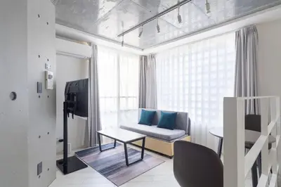 a living room with a couch and a table at \u30eb\u30af\u30ec\u6771\u65b0\u5bbf in Tokyo