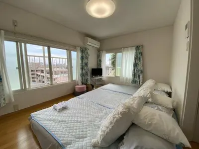 a bedroom with a bed and a large window at Tokyo downtown\u7261\u4e39\u838a in Tokyo