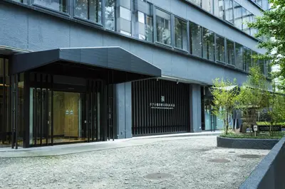 a large building with a black entrance to it at Hotel Ryumeikan Ochanomizu Honten in Tokyo