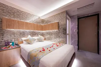 a bedroom with a large bed and a brick wall at Exquisite business hotel Bella in Tokyo