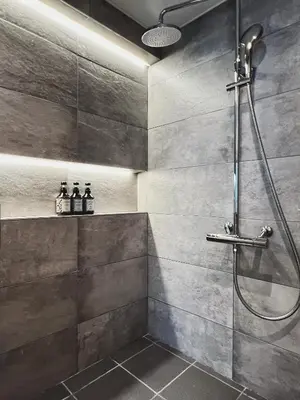 a bathroom with a shower with a glass door at Exquisite business hotel Bella in Tokyo