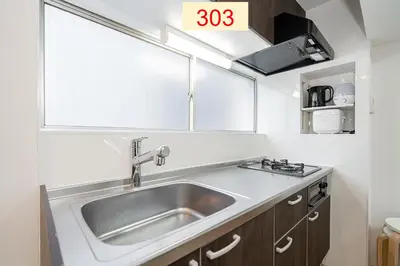 a kitchen with a stainless steel sink in a kitchen at Downtown Apartment/ SHIBUYA Station 10mins on foot in Tokyo