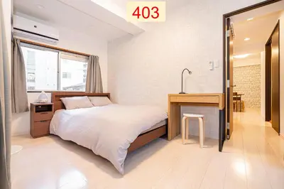 a bedroom with a bed and a desk and a sink at Downtown Apartment/ SHIBUYA Station 10mins on foot in Tokyo