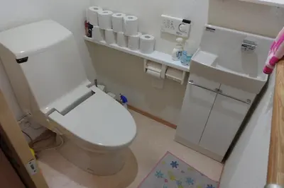 a bathroom with a white toilet and a sink at WOMEN ONLY 3F in Tokyo