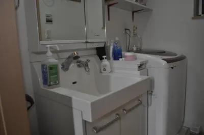 a bathroom with a sink and a washing machine at WOMEN ONLY 3F in Tokyo
