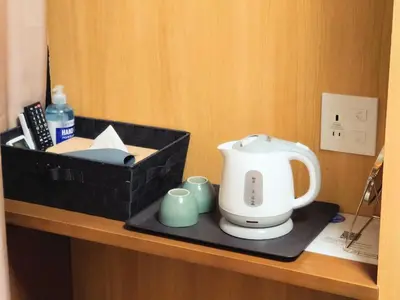 a counter with a tea kettle and cups on it at Oda hotel Akihabara in Tokyo