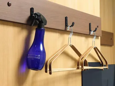 a blue detergent bottle is hanging on a wall at Oda hotel Akihabara in Tokyo
